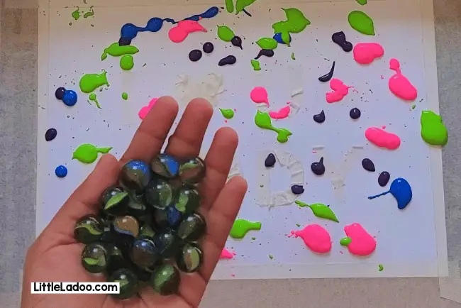 Drop marbles on the paper
