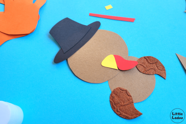 Paper turkey craft add beak, wings and hat