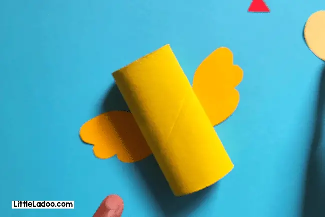 Attach wings to the toilet paper craft