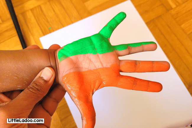Paint orange and green on hand