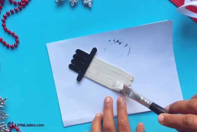 Painting the popsicle stick snowman