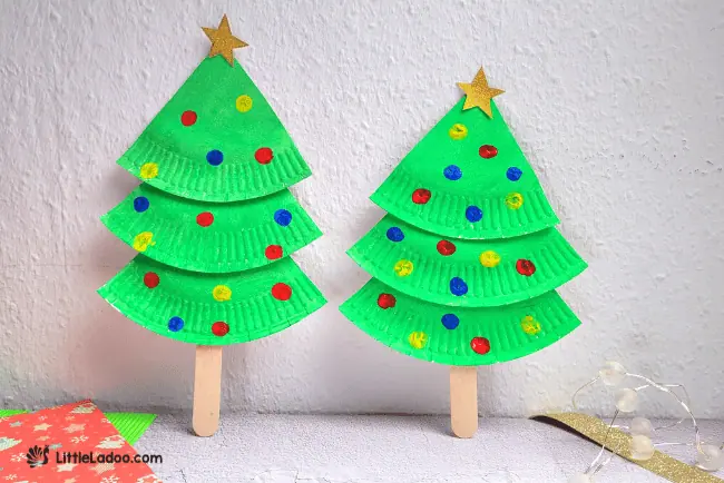 Our green Christmas tree is ready with red and blue paint and a golden star